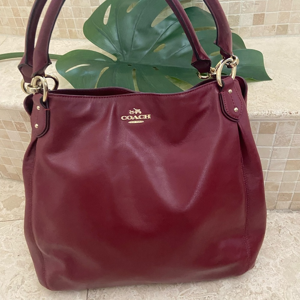 Over the shoulder, large coach bag. Burgundy beautiful has a little damage